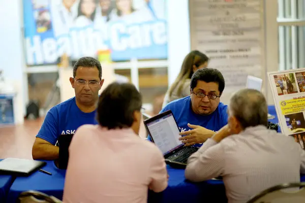 ACA insurance agent advising a customer on Affordable Care Act plans, showcasing plan benefits